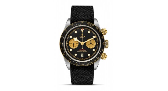 a black watch with gold crown and pushers and subdials