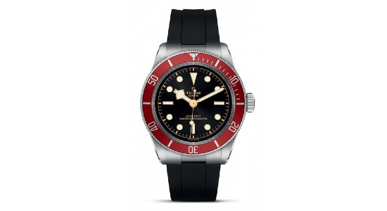 a stainless steel watch with black dial, red bezel, and rubber strap