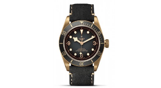 a black and bronze watch from TUDOR with a leather strap